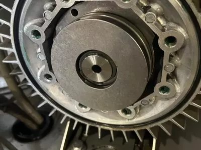 Close-up of new wobble disc installed inside pump assembly during servicing of a Nilfisk SH Truck Booster, ensuring smooth and reliable pump operation.